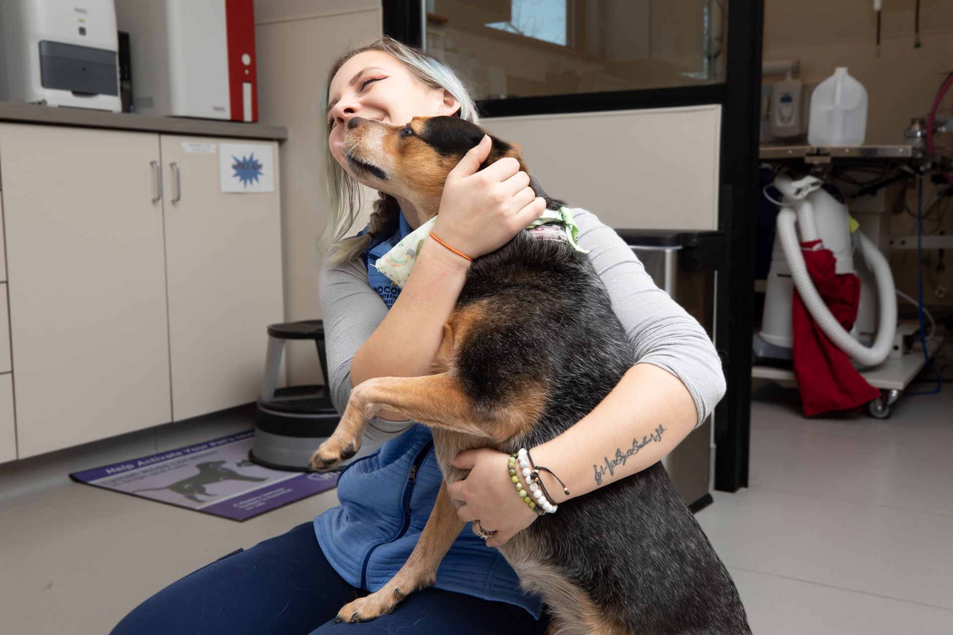 a woman holding a dog in a room